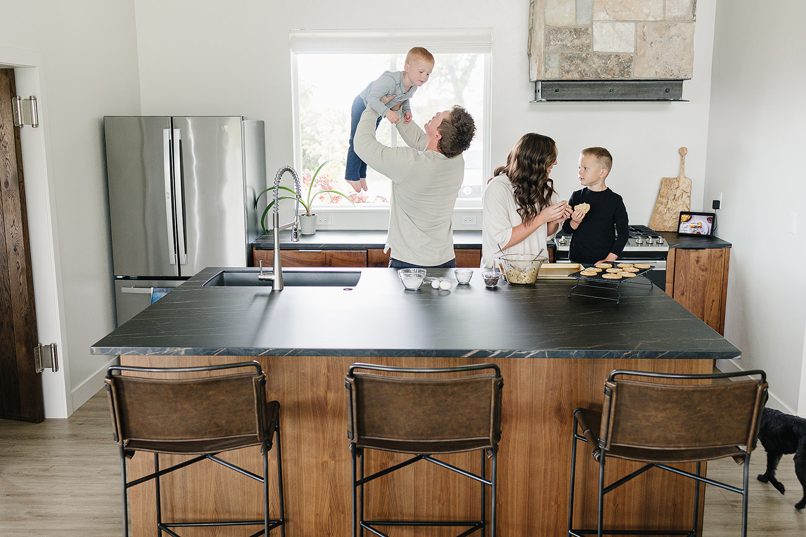 Evo Granite by Nicole happy family gathered in a kitchen featuring evolution design countertops